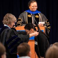 Woman bows to receive cord